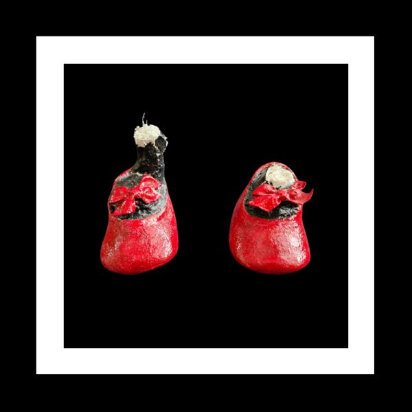 Little Red Running Shoes. A tiny pair of red shoes with ribbon bows, and part ankles.