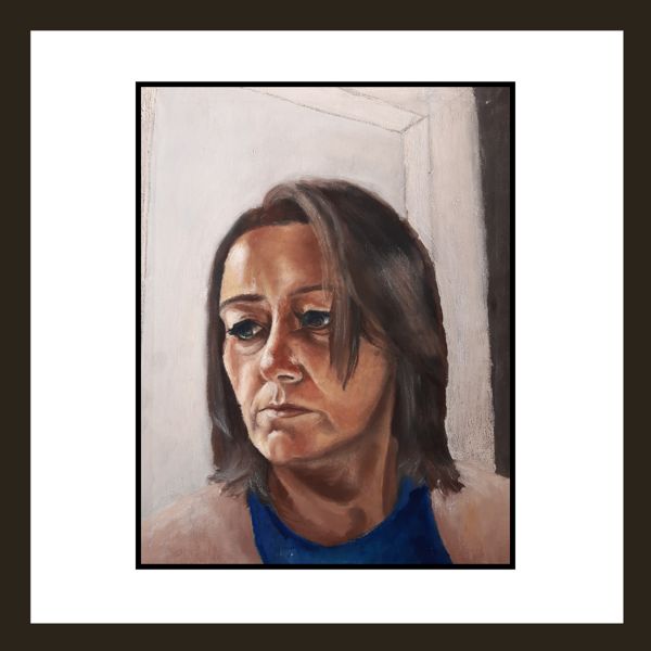Quiet Contemplation. A woman looks down and away, caught in her own thoughts against a pale doorway.