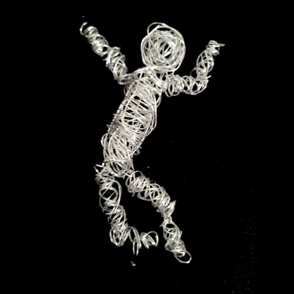 Wired Dancer. A figure made from looping silver wire, mid-leap, arms flung up.